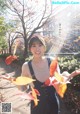 A woman holding a bunch of leaves in her hands.