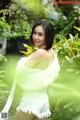 A woman in a white dress posing for a picture.